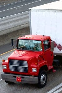 Red Cargo Truck Driving on the Road