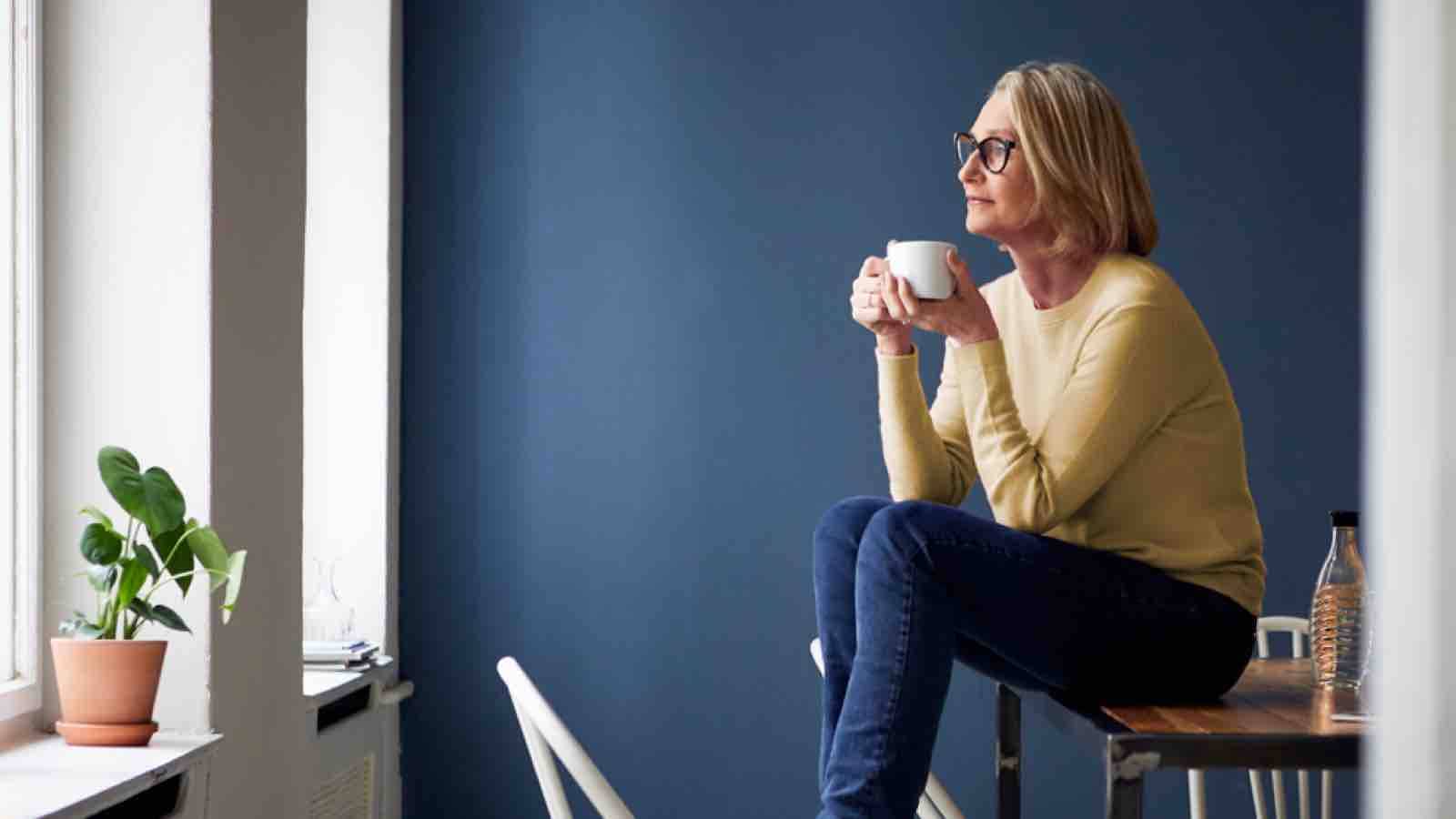 Older woman drinking coffee and contemplating life