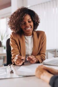 Errors and omissions insurance being explained to a businesswoman.