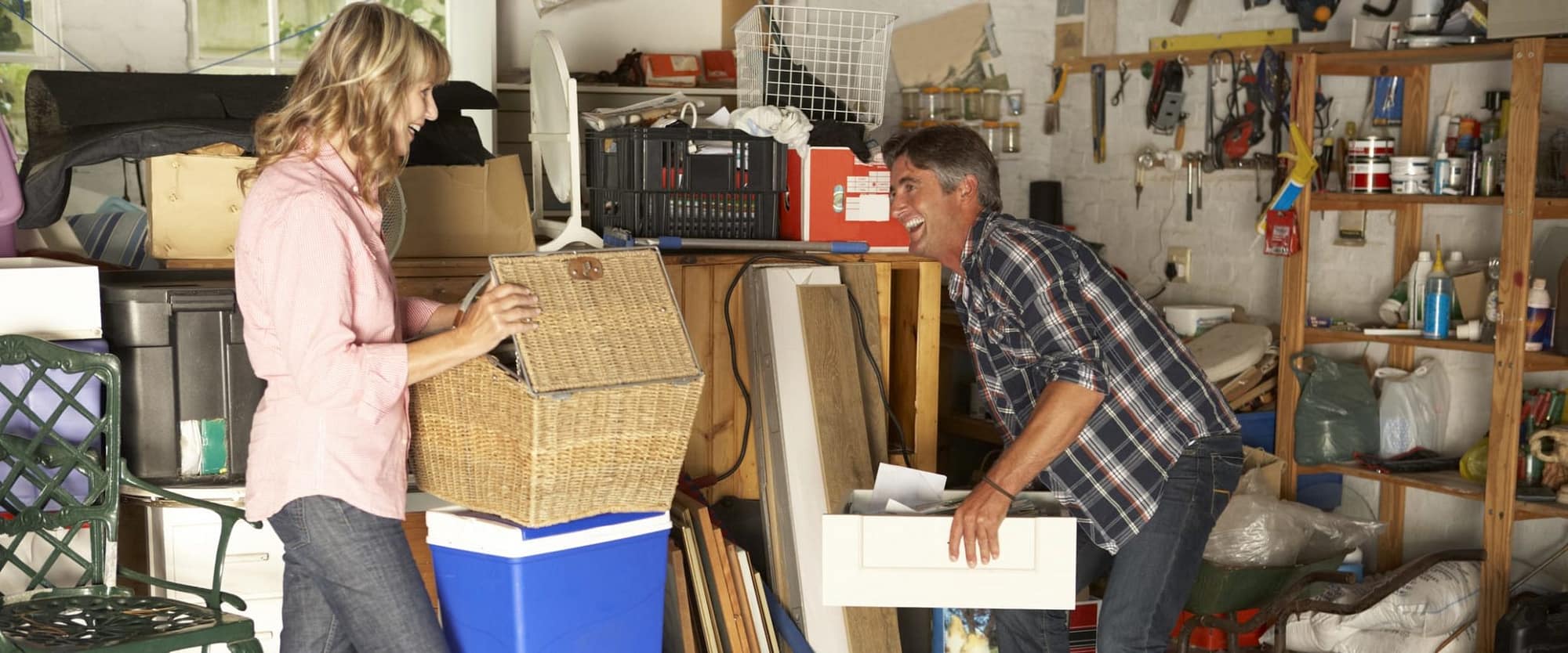 Happy Man and Woman Storing Objects in Garage
