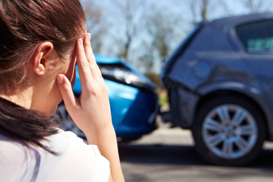 Woman in car accident holding her head