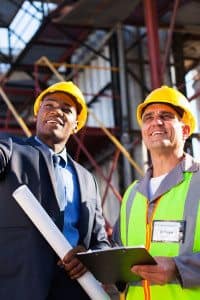 Businessman and Construction Worker Talking on Construction Site
