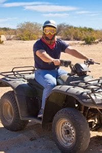 Man Sits on ATV while Looking at the Camera