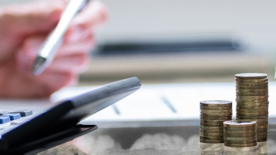 commercial insurance desk with coins and calculator
