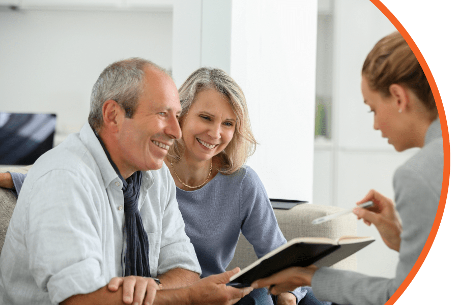 LifeInsurance woman walking a senior couple through a notebook