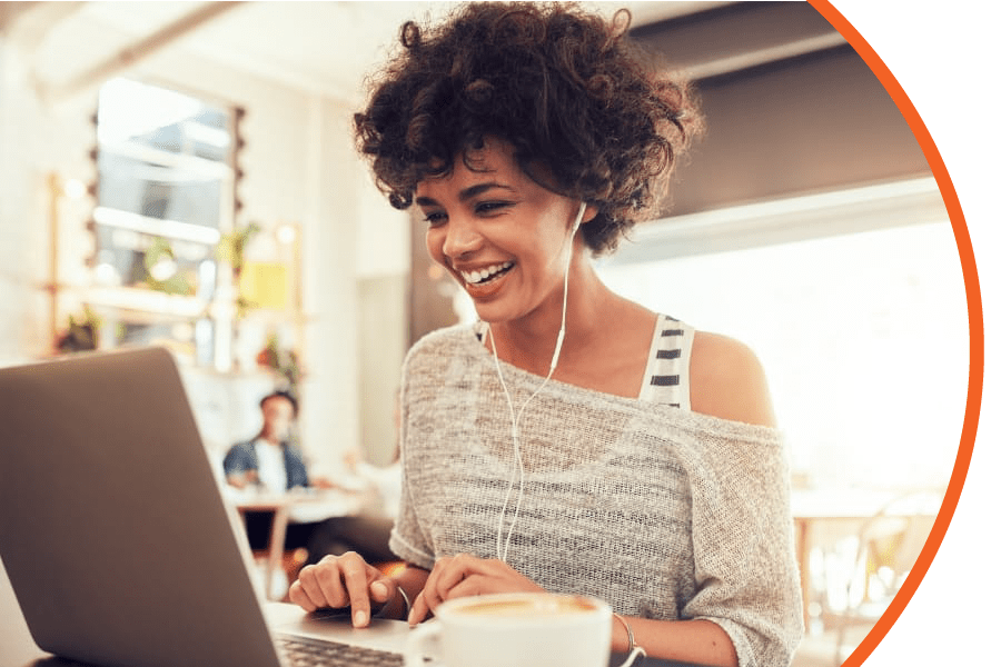 OurVideos mixed race woman laughing while looking at laptop