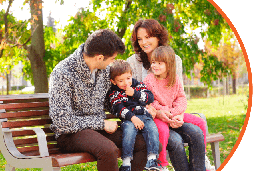 contact family sitting on park bench