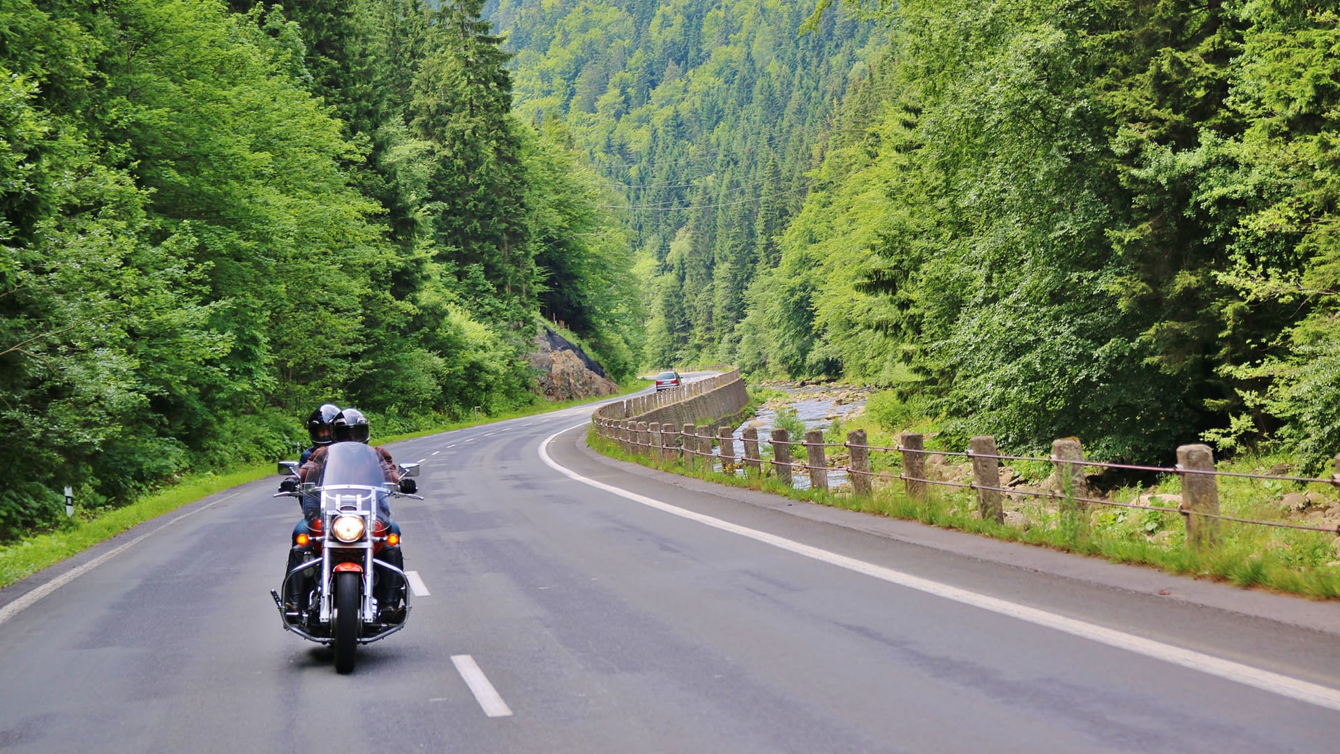 Motorcyle driving through mountain roads.