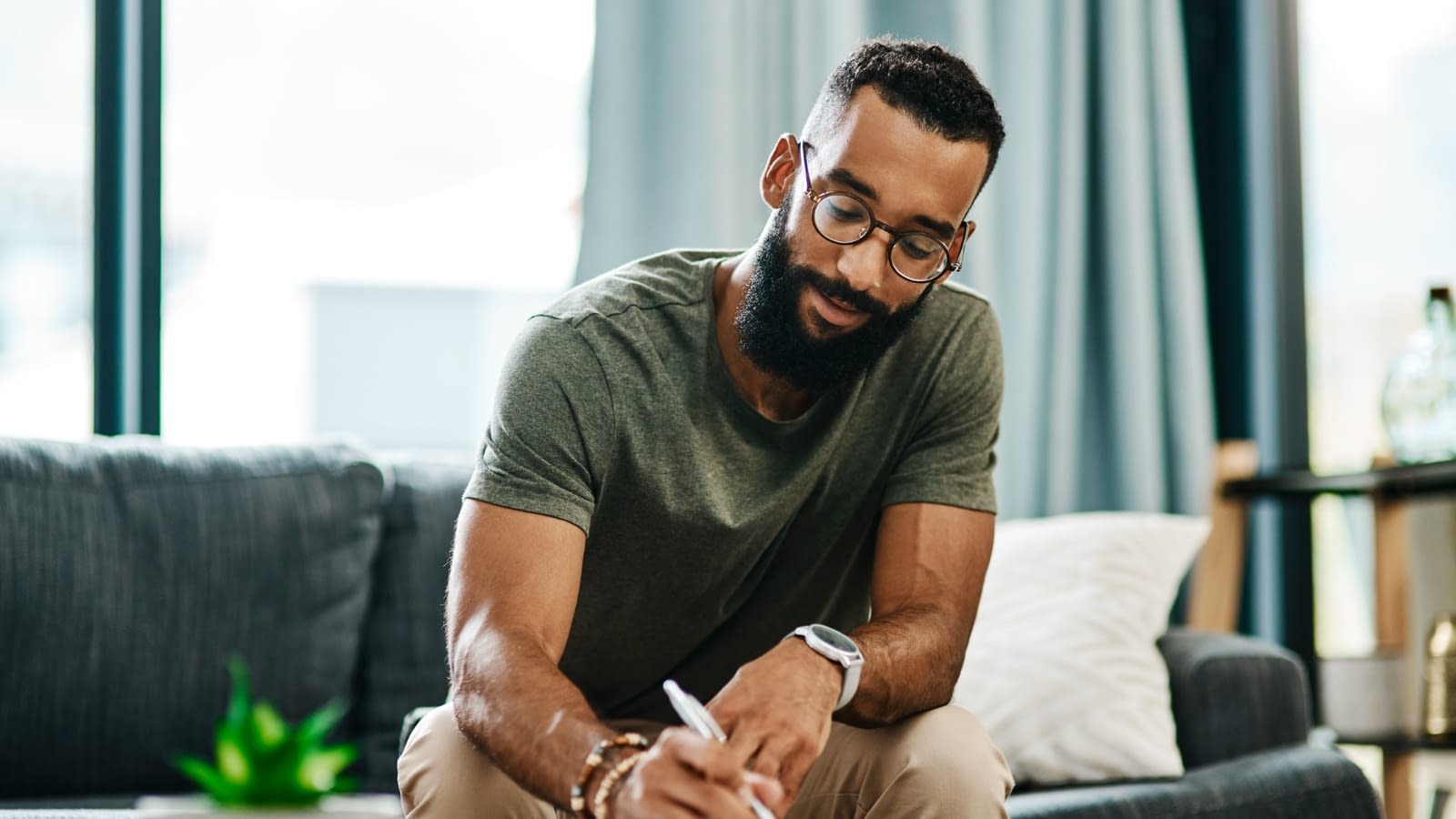 Young male looking over documents man taking down notes