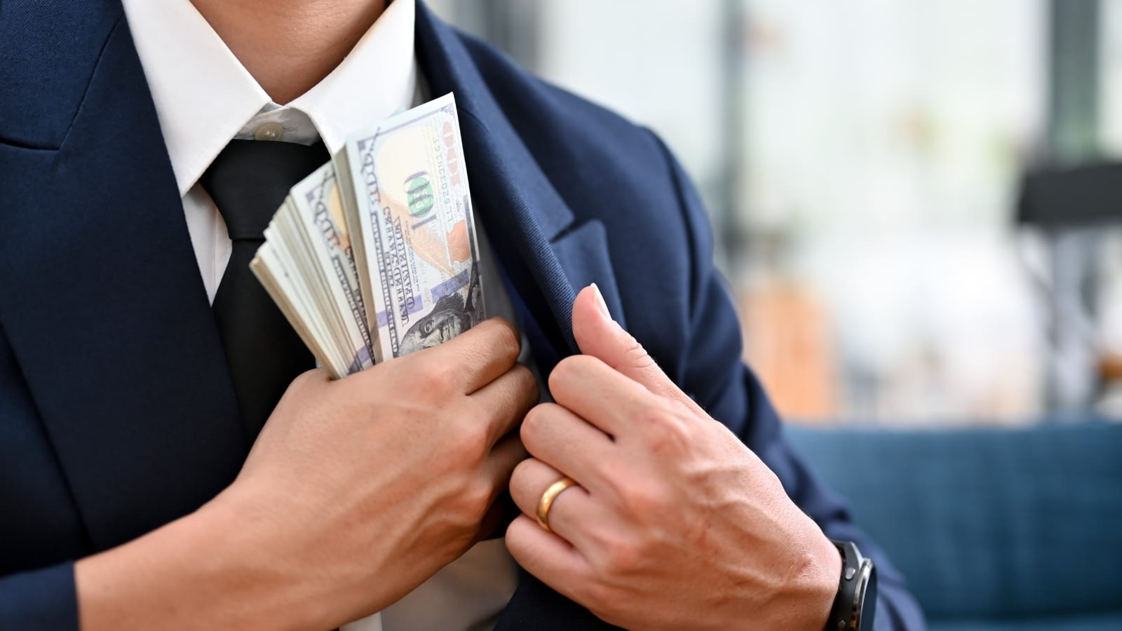 businessman pocketing company money