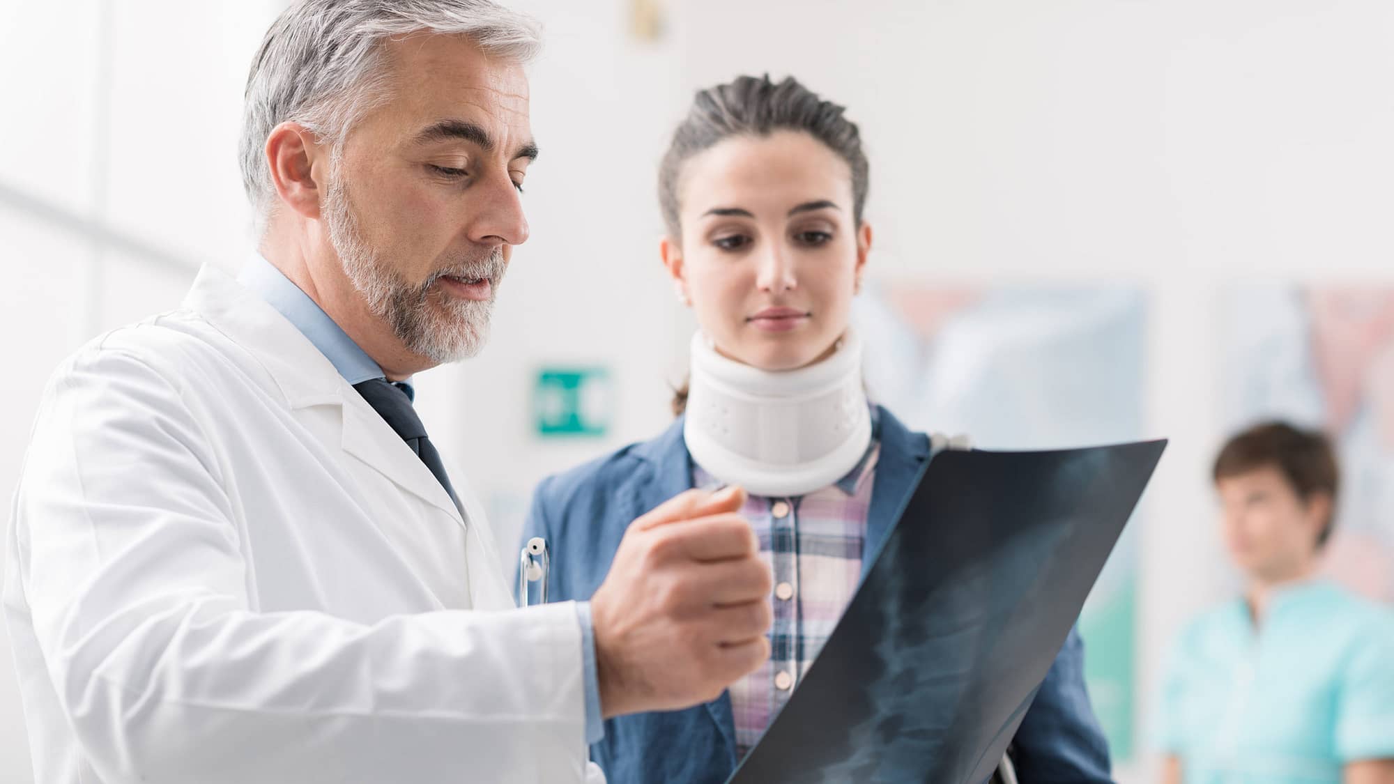 Doctor showing a young female patient her x-ray.