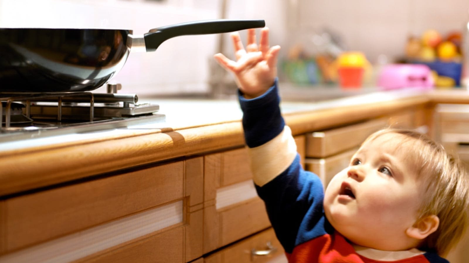 home-safety-large Toddler reaching for the stove