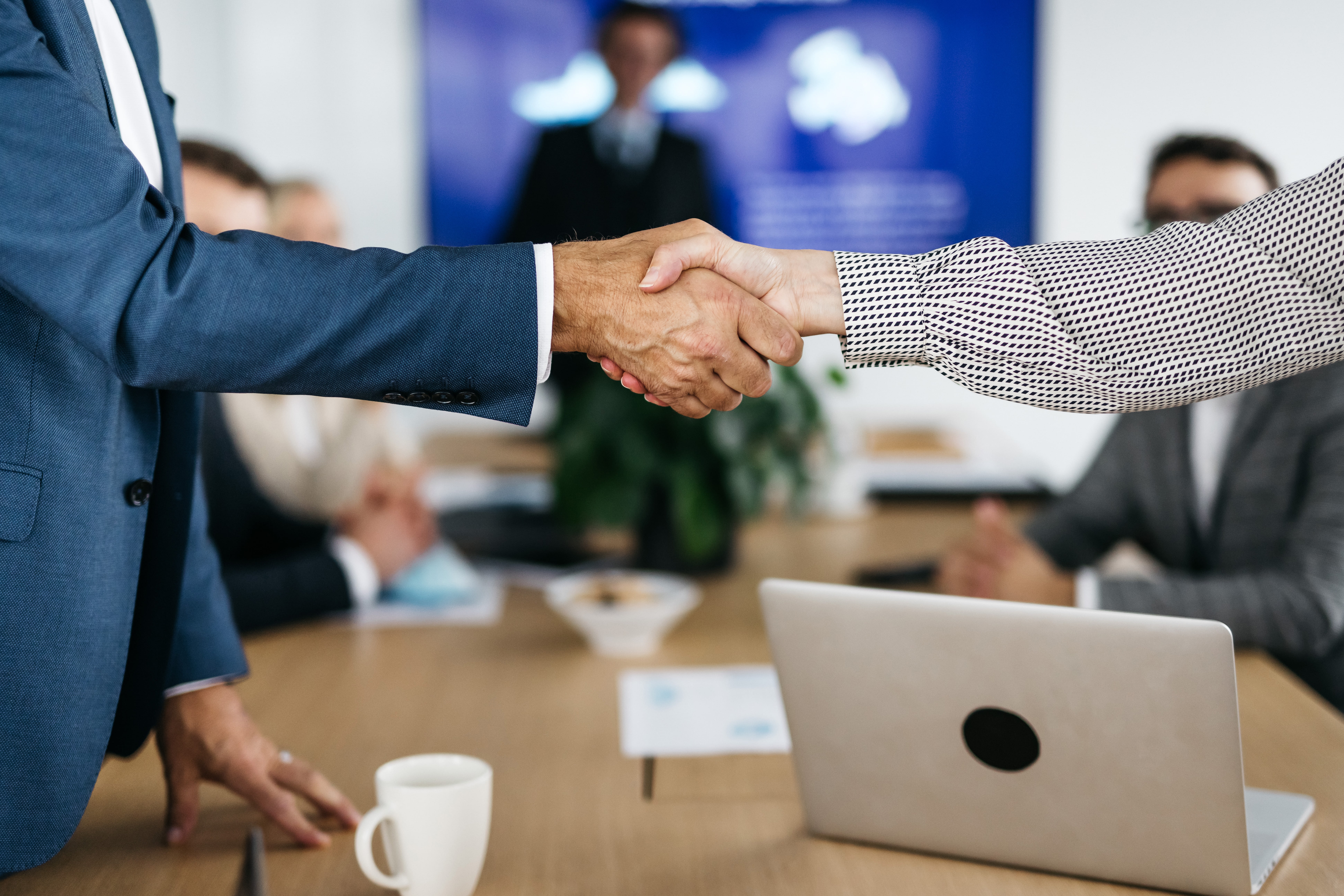 colleagues shaking hands in a board room