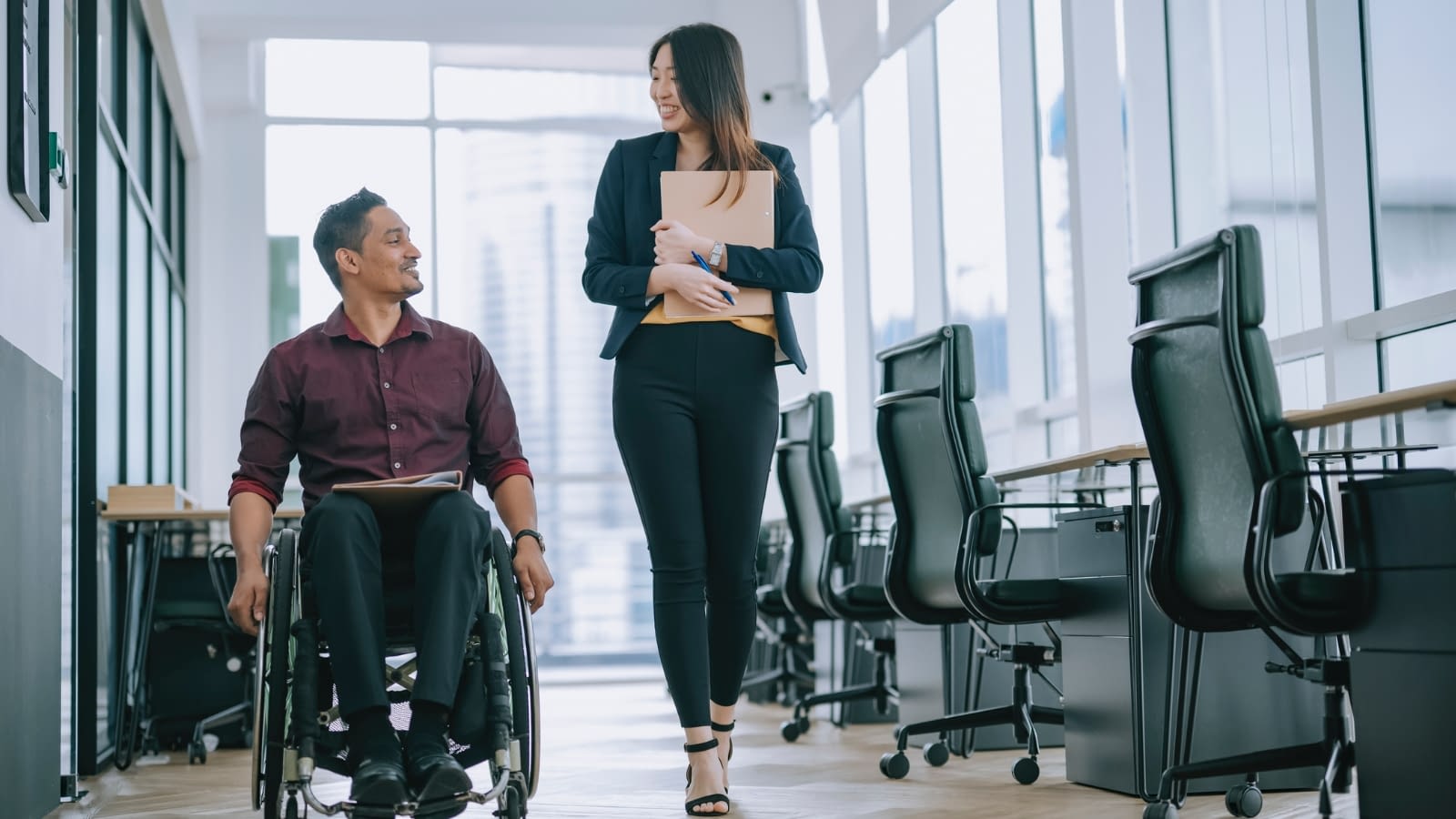 networking man in wheelchair talking to woman beside him