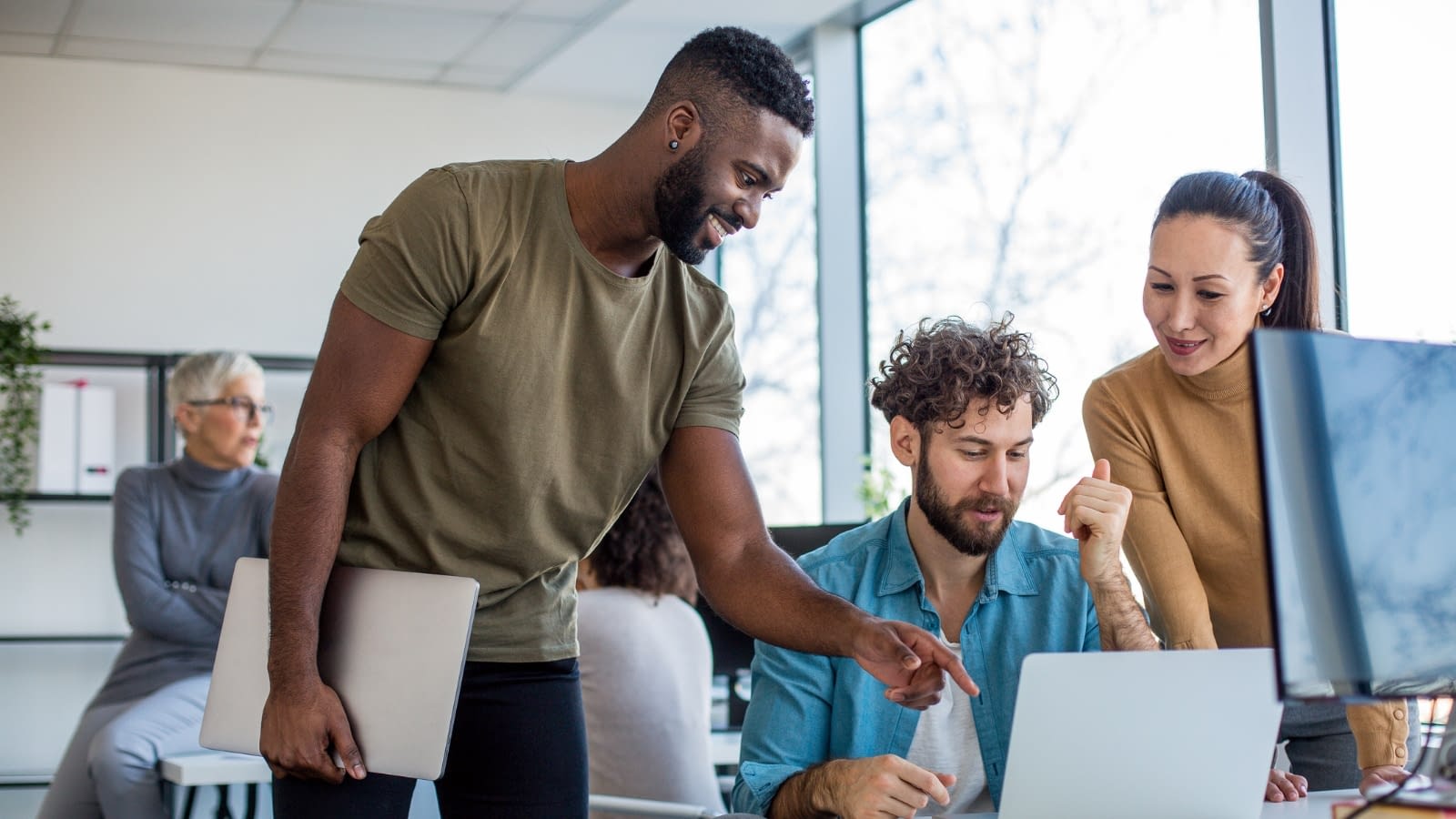 April 28 blog Young co-workers collaborating in office.