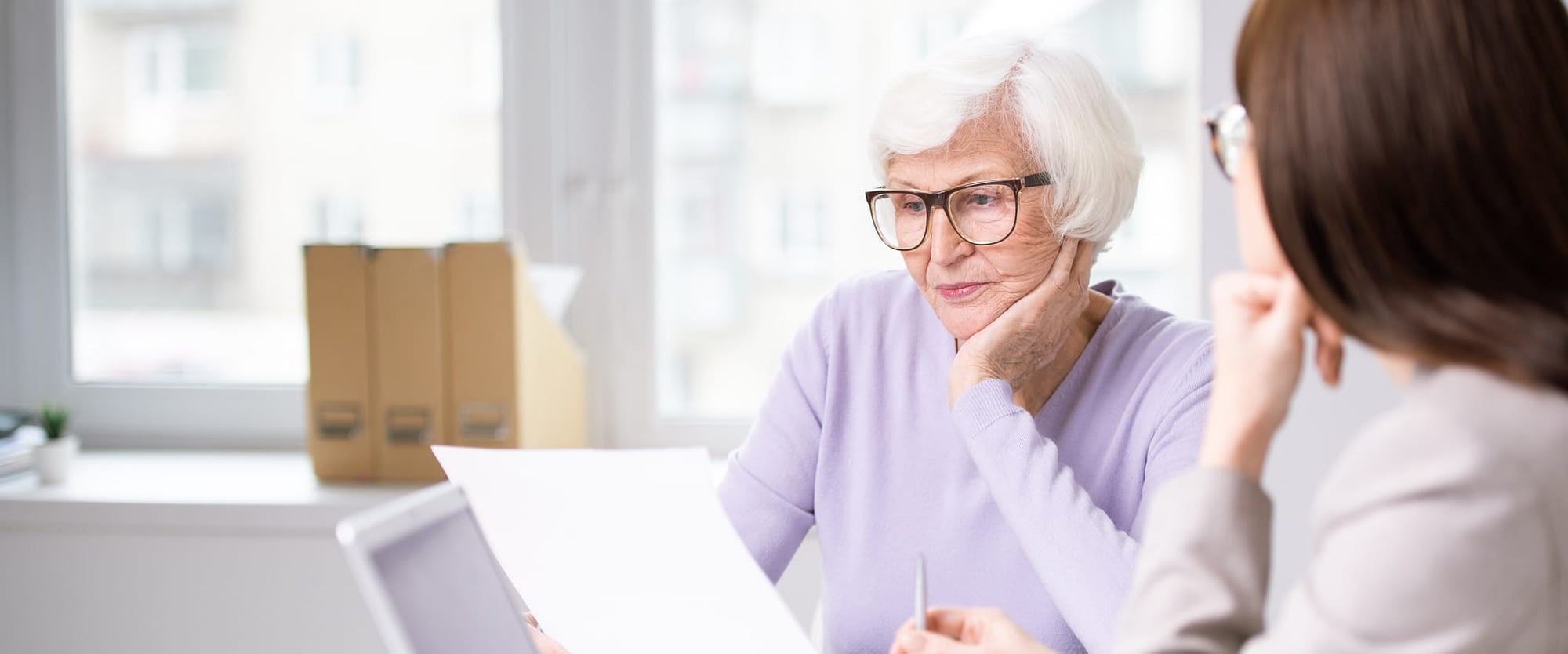 Serious Senior Woman Reviewing Paperwork