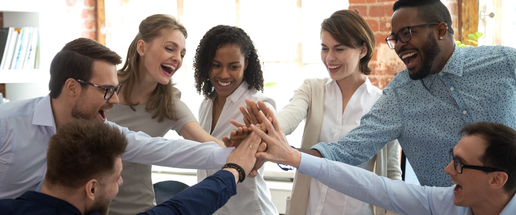 How to Brighten Your Employee Benefits This Summer Happy Coworkers Giving High Five