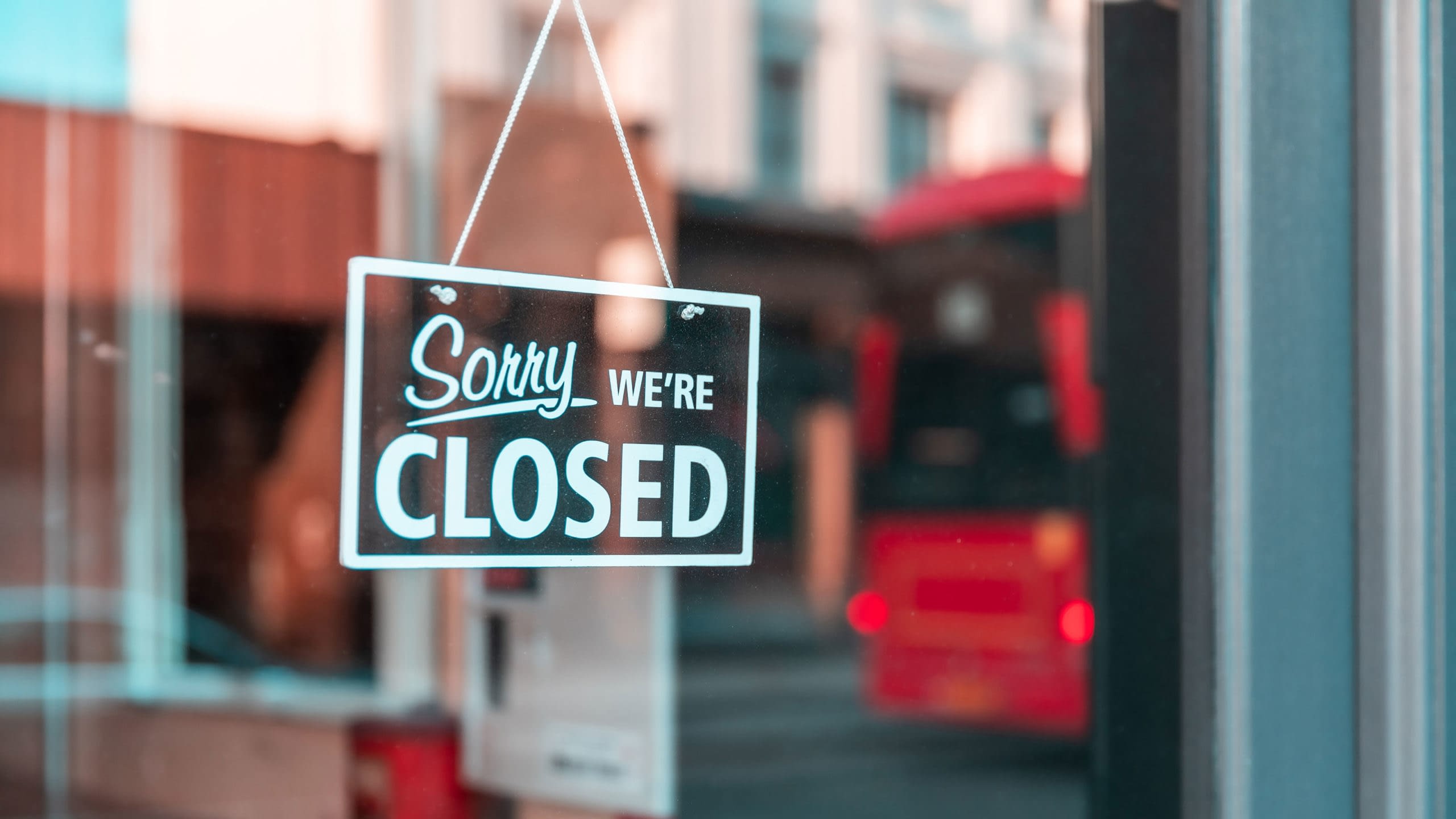 Sorry We're Closed sign on the front door of a business.