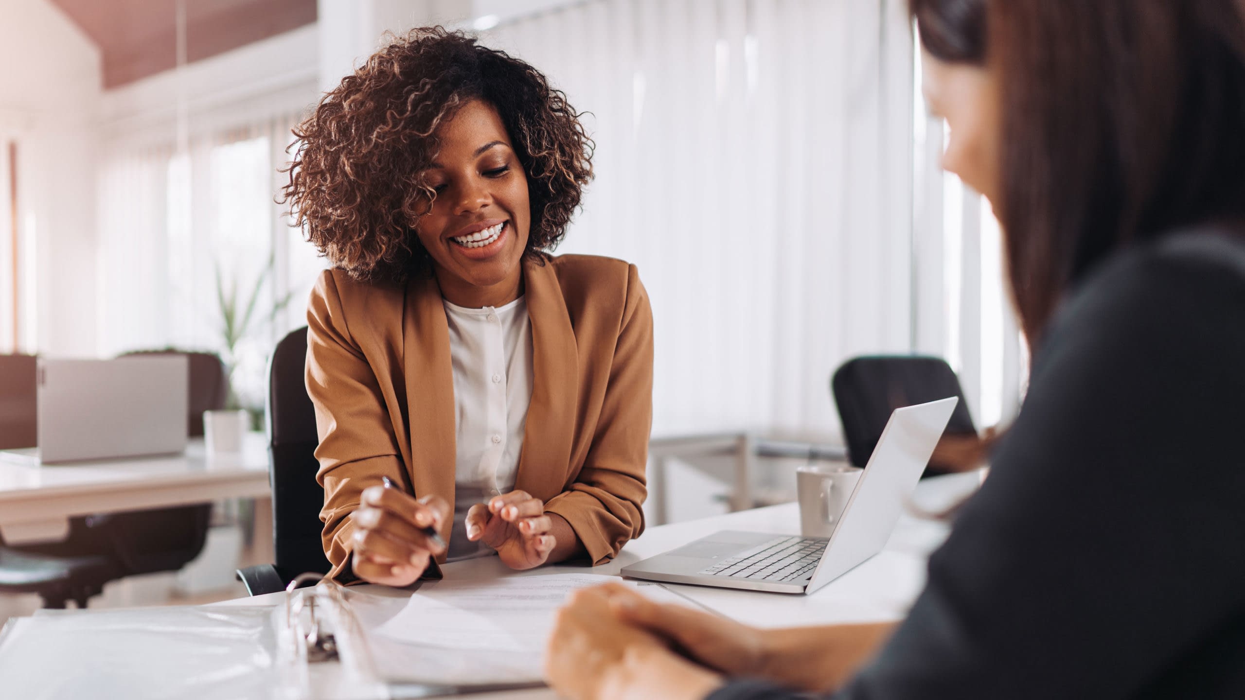 Errors and omissions insurance being explained to a businesswoman.