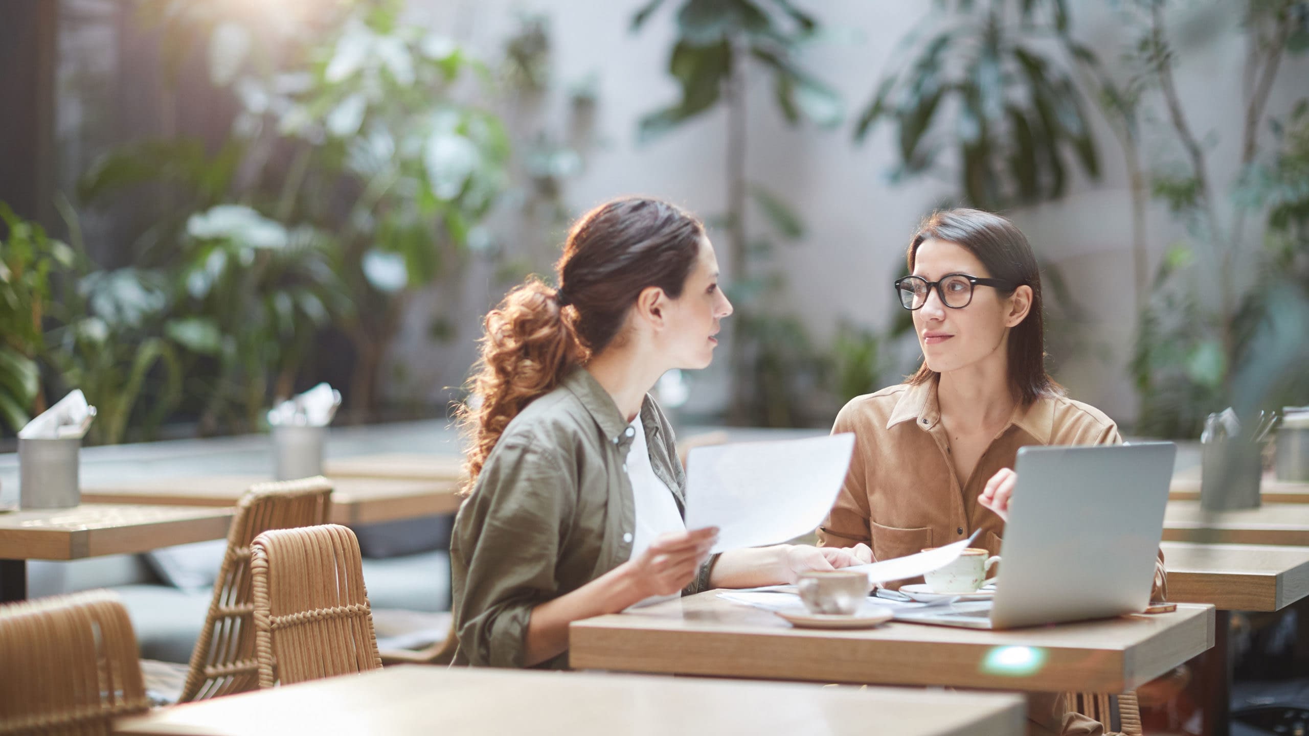 Two young businesswomen discussing buy /sell protection.