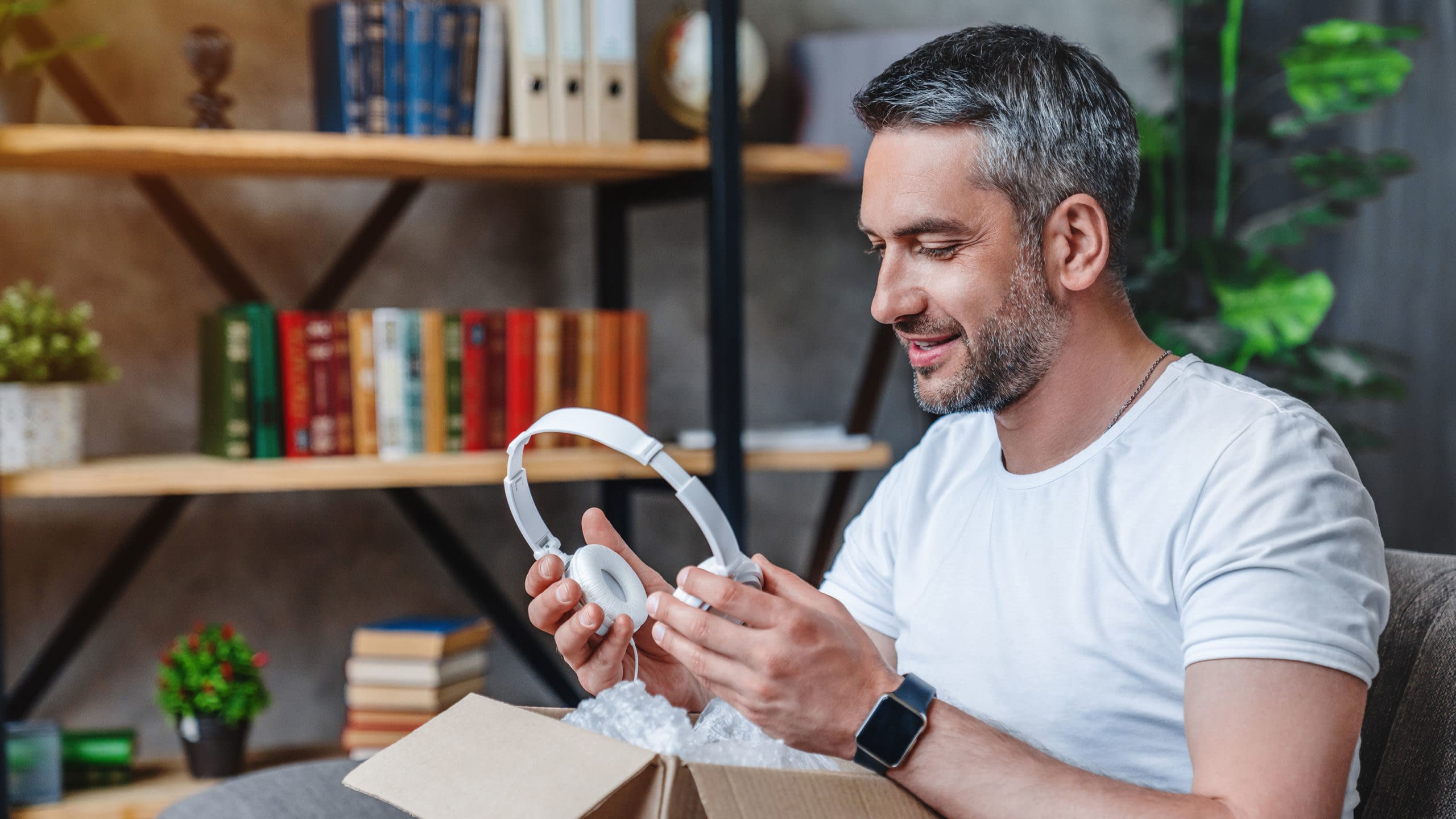 Man unboxing a new pair of headphones.