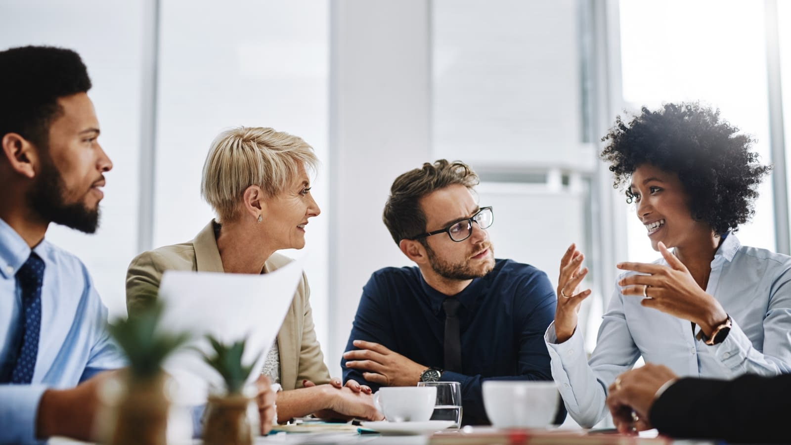 goal setting businesswoman talking to a group of coworkers