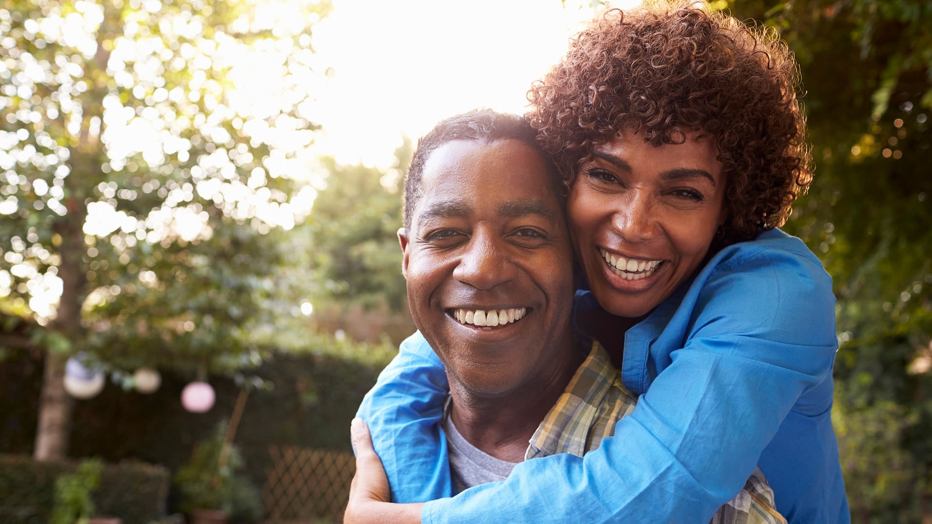 Close up of retired couple smiling at the camera.