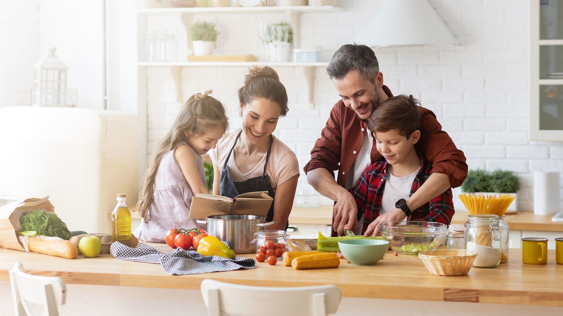 Family preparing a meal together in their kitchen.