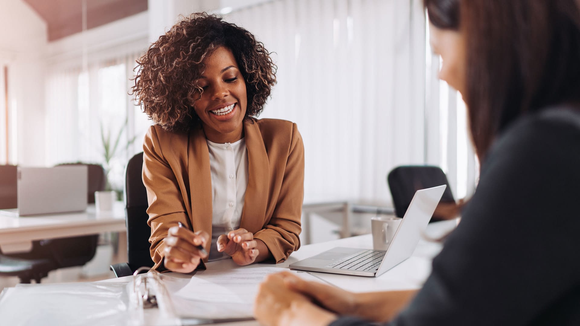 Errors and omissions insurance being explained to a businesswoman.