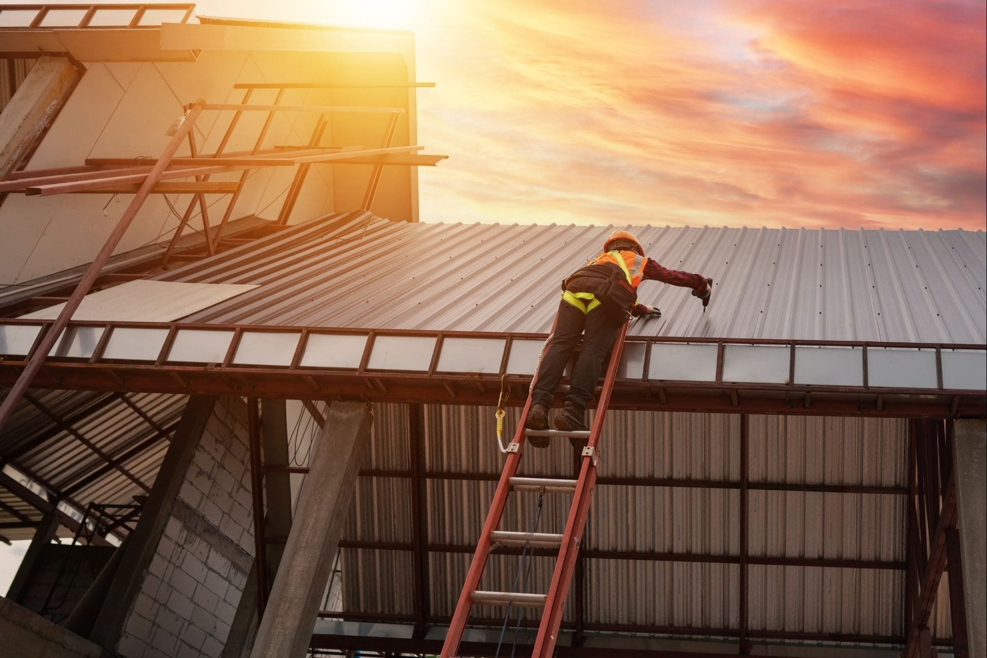 BLOG MAGES (1920 x 1280 px) (53) Roofer on a ladder fixing a commercial building's roof