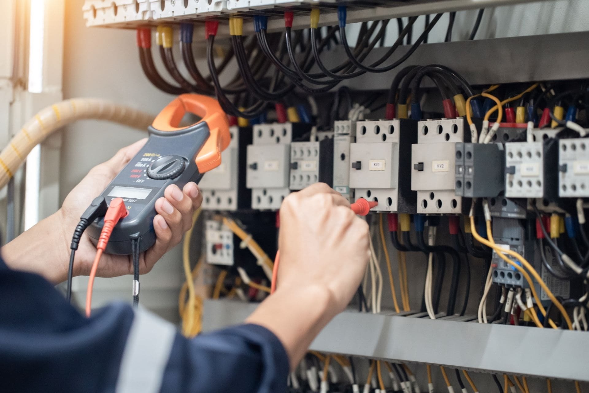 Electrician Insurance in Wilmington What Your Business Needs electrician working on electrical box in Wilmington NC