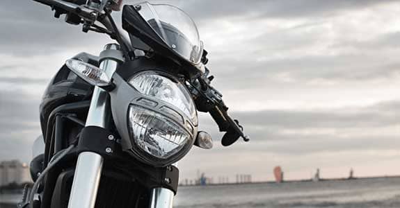 front_end_of_motorcycle_with_water_in_the_background_575x300