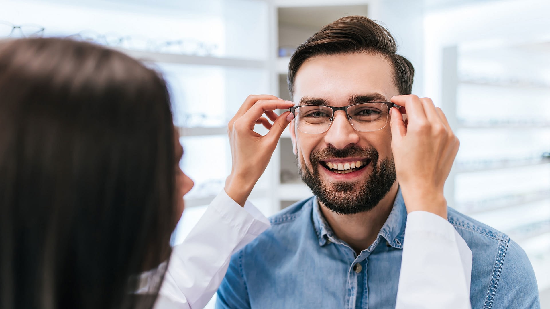 Man getting fitted with new glasses by an optometrist.