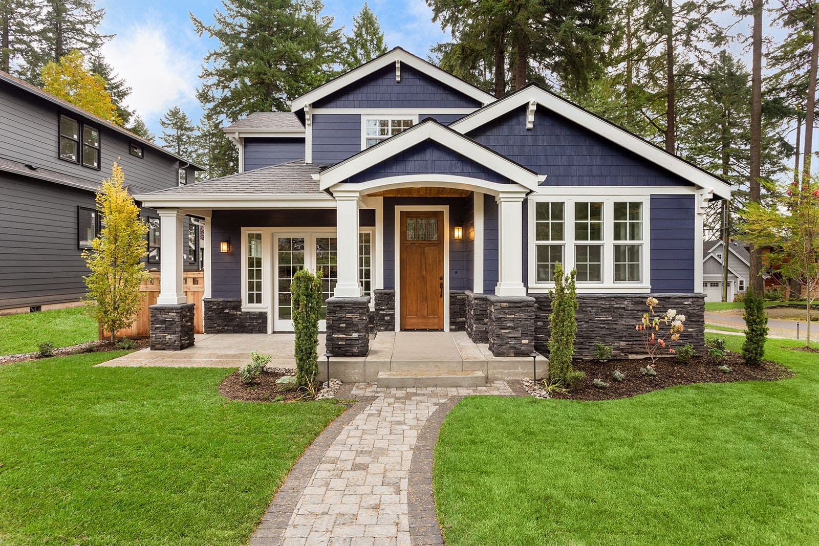 blue-craftsman-style-house-with-green-yard