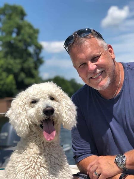 Dewberry-Insurance—Content—Steve-and-Annie Steve and His Dog Annie smiling for photo together