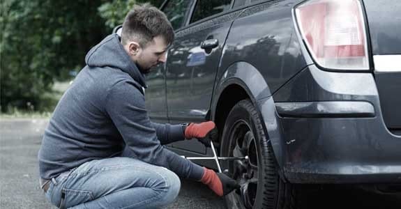 someone_changing_a_car_tire_575x300 Man Changing Car Tire