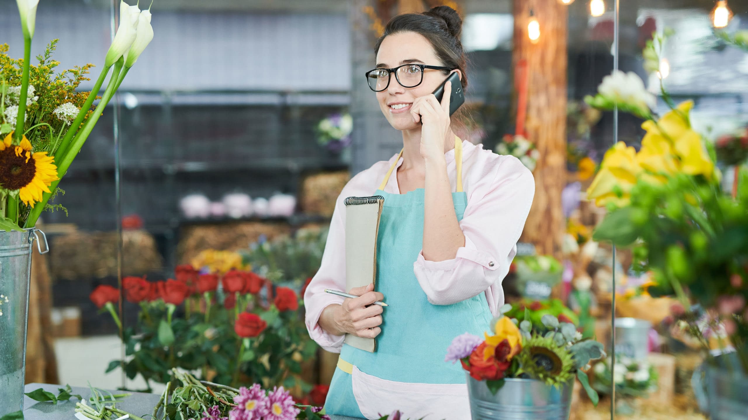 Young businesswoman on phone discussing QSHERA.