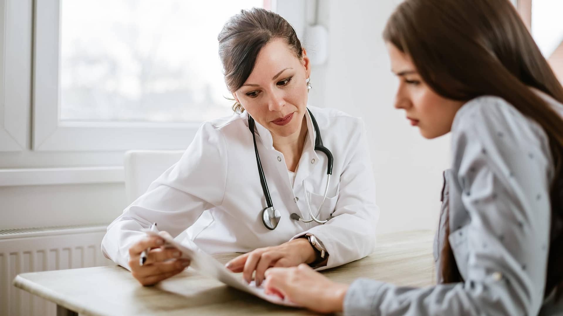Woman going over test results with her female doctor