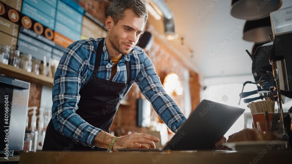 Restaurant Owner Using Laptop