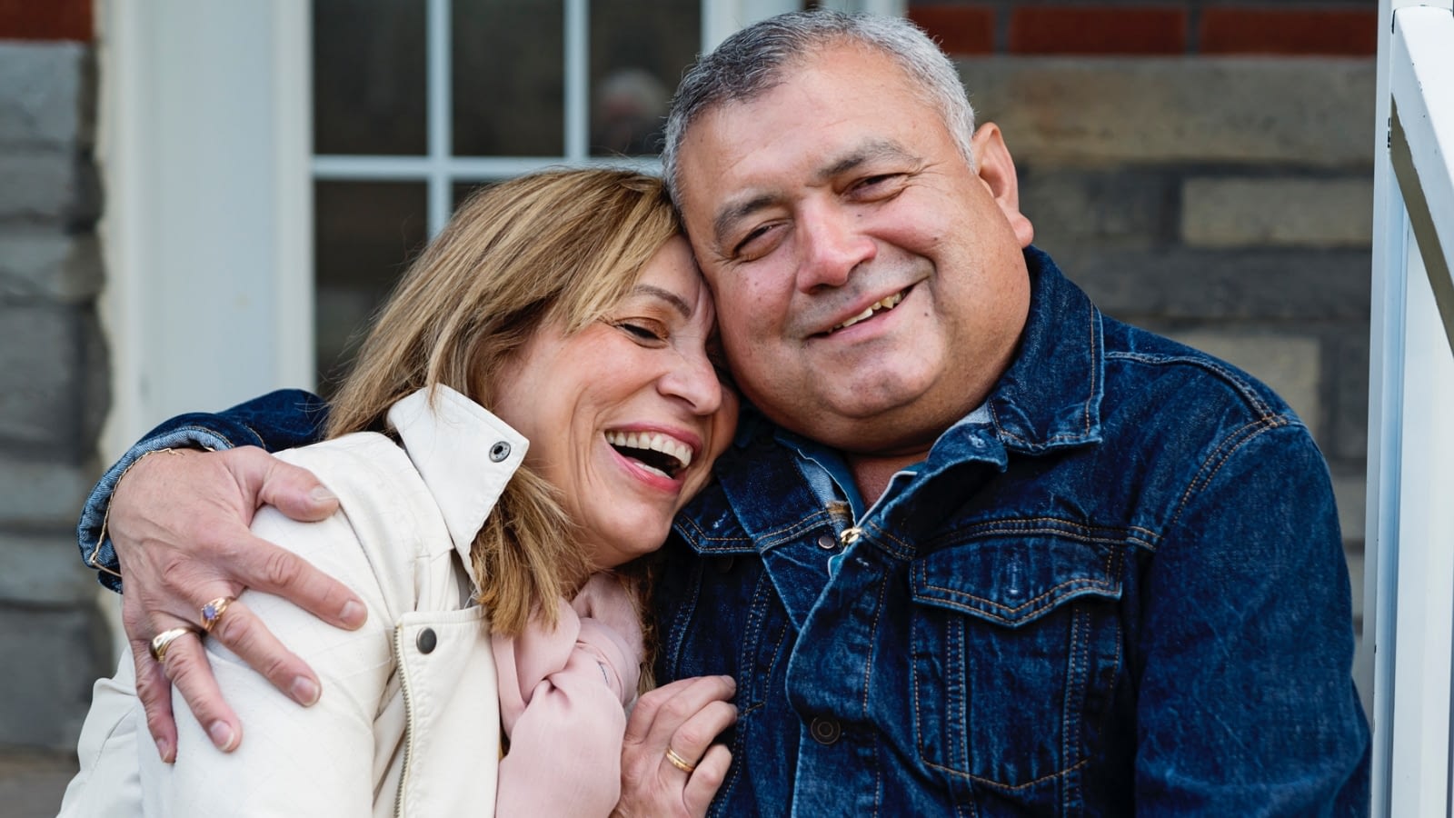 senior latino couple embracing and smiling
