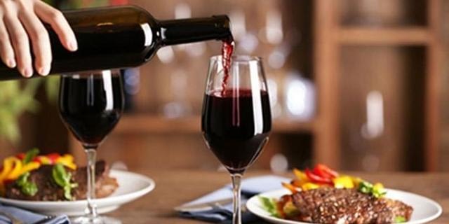 Pouring Wine into Glass at Dinner