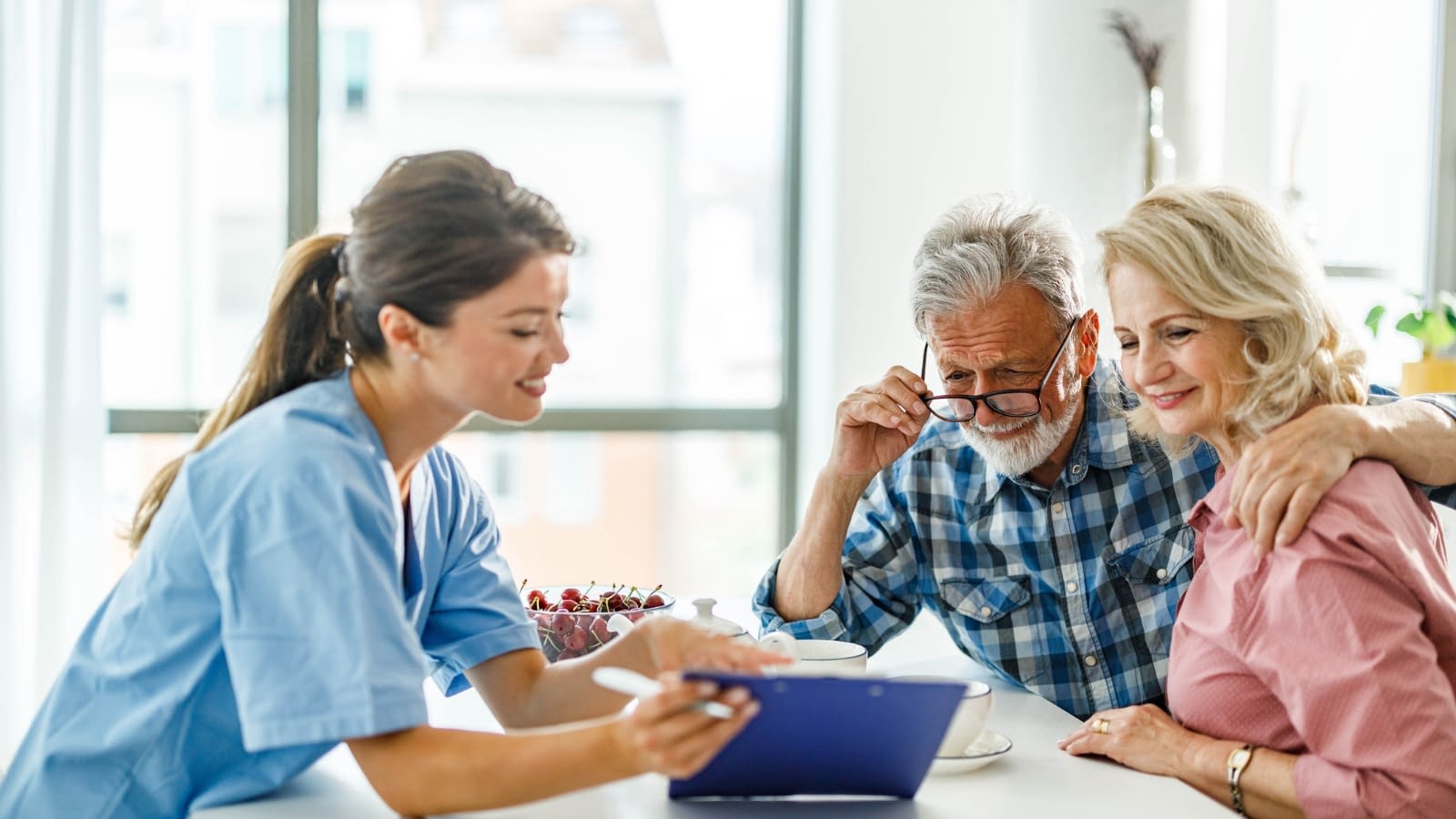 Older couple discussing Medicare options with doctor.