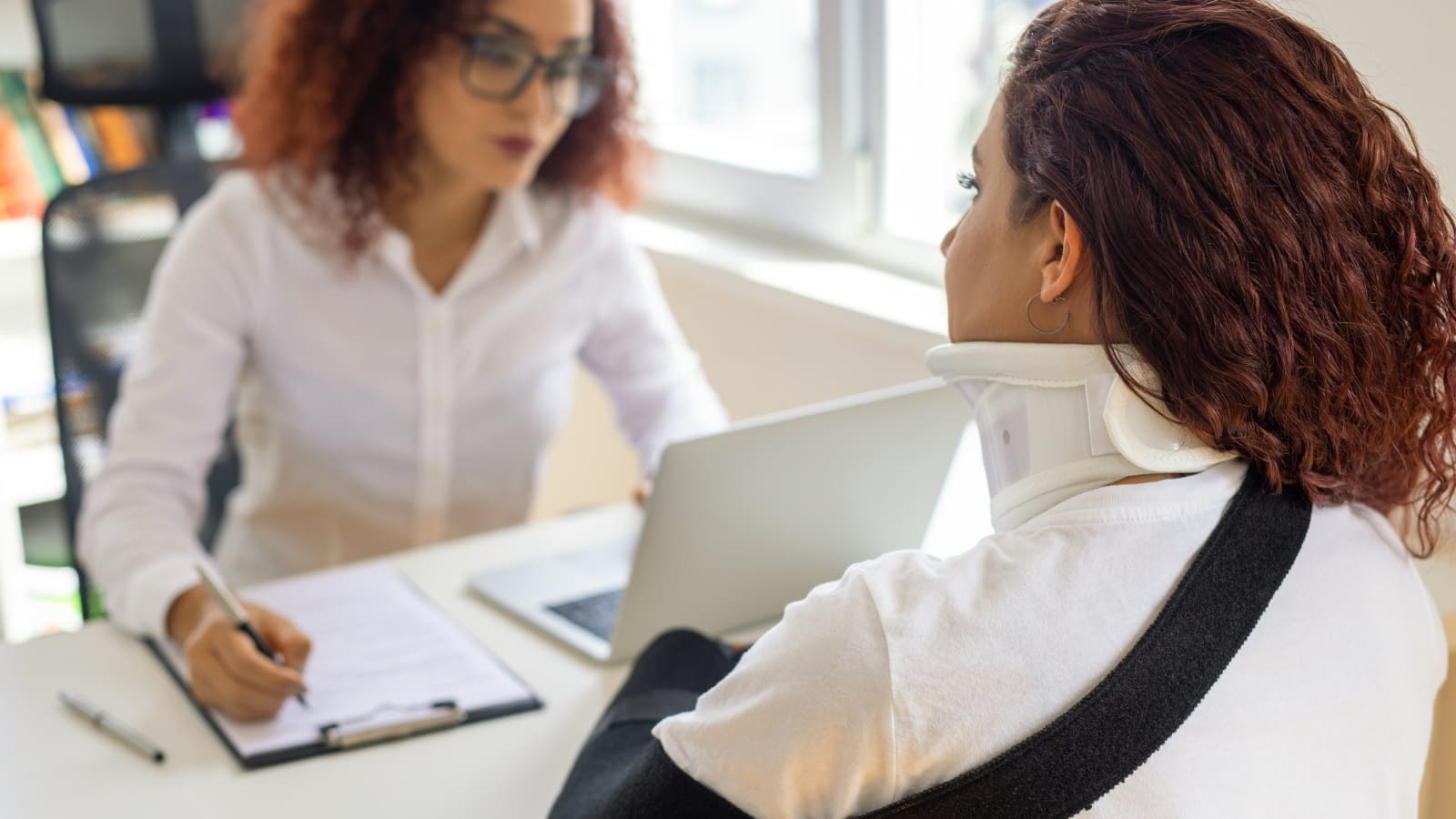 safer workplace injured employee speaking with businesswoman