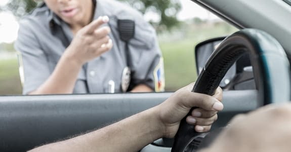Police officer looking into a car