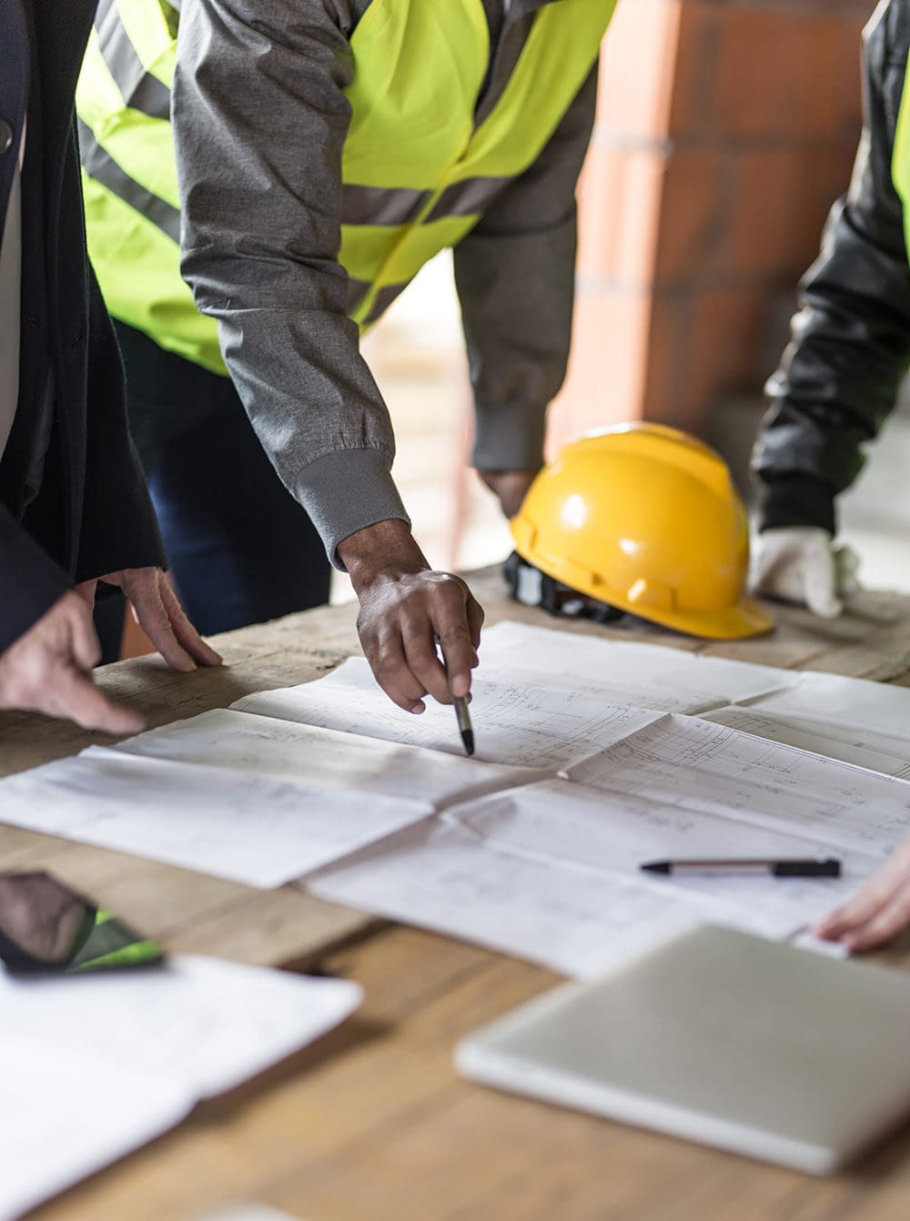 Contactors-looking-at-blueprint-at-site