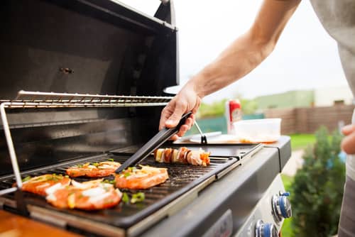 Hand,Of,Young,Man,Grilling,Some,Meat,And,Vegetable-meat,Skewers