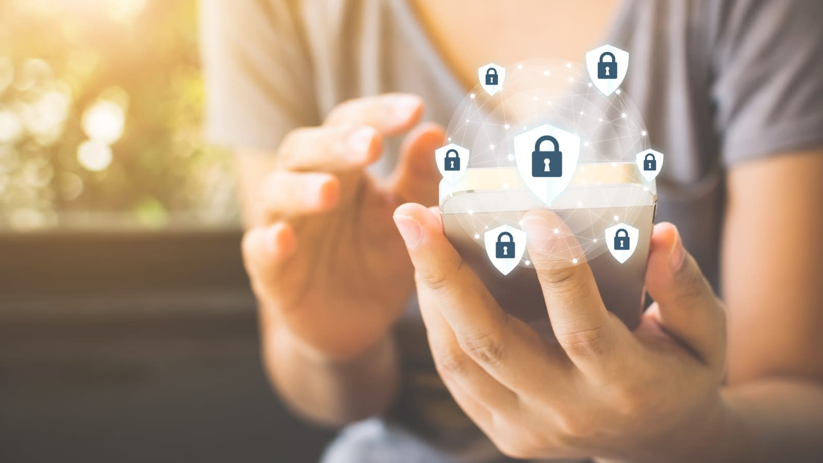 identity theft women looking at phone with security icons surrounding it