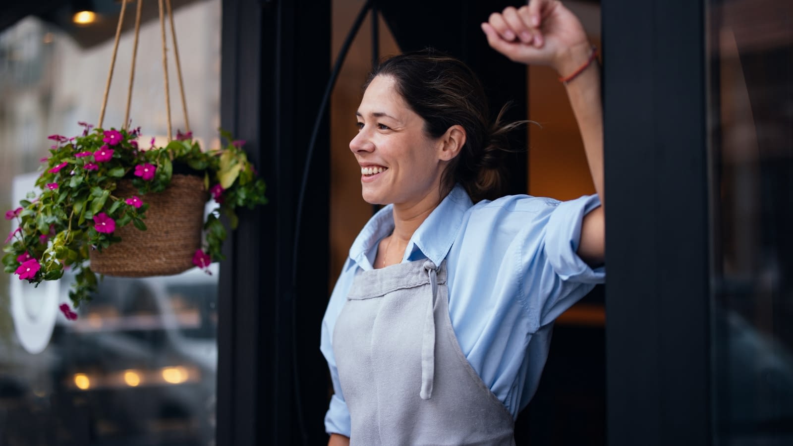 Jan 7 Blog smiling female business owner standing outside of her shop