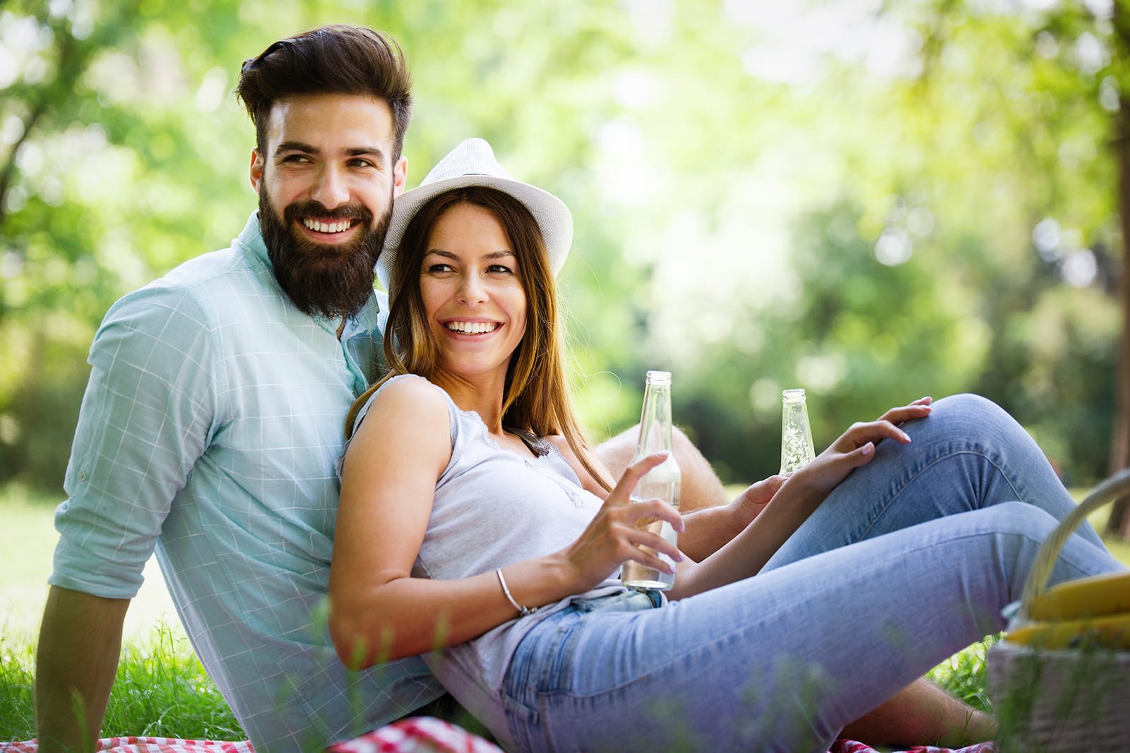 happy-young-couple-enjoying-picnic-in-park-2021-08-26-17-35-08-utc