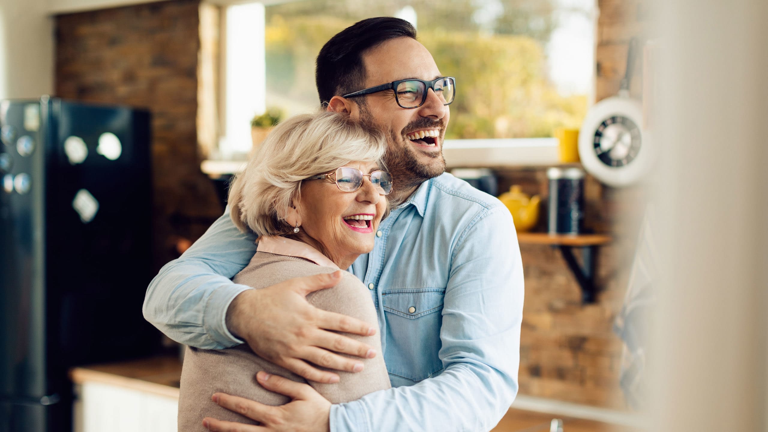 Happy senior mother and son embrace.